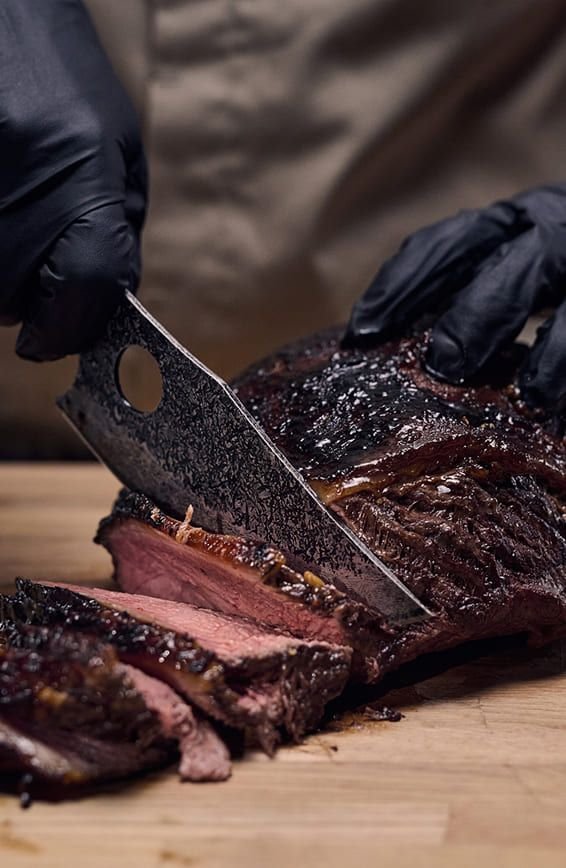 Matsato knife slicing a smoked beef brisket